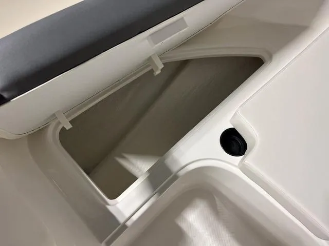 Slide: The Image of Storage compartment of 2024 Bayliner E18 LTD boat with cushioned seating. - 23