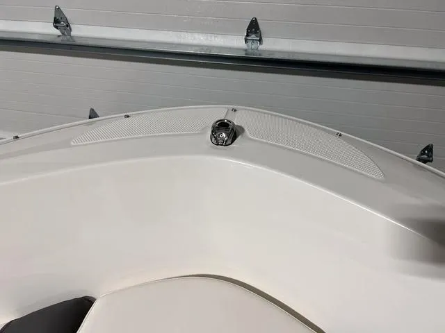 Slide: The Image of 2024 Bayliner E18 LTD boat bow in a garage. - 25