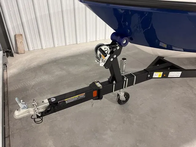 Slide: The Image of 2024 Bayliner E18 LTD boat trailer hitch and winch system in a storage facility. - 3