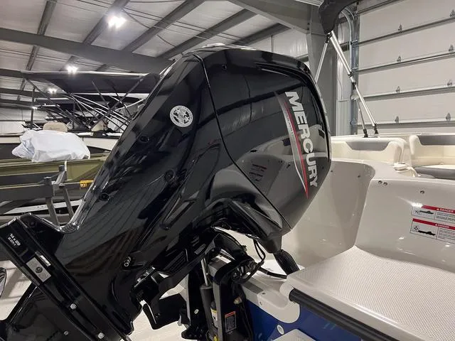 Slide: The Image of 2024 Bayliner E18 LTD with Mercury outboard motor in a showroom. - 6