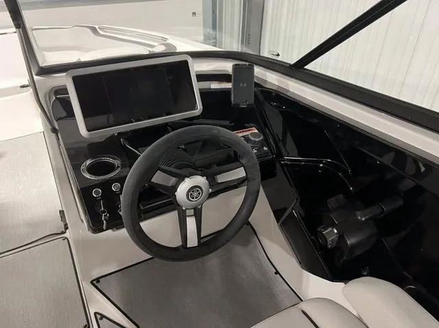 Slide: The Image of 2024 Yamaha Boats AR250 helm with steering wheel, touchscreen display, and control panel. - 13