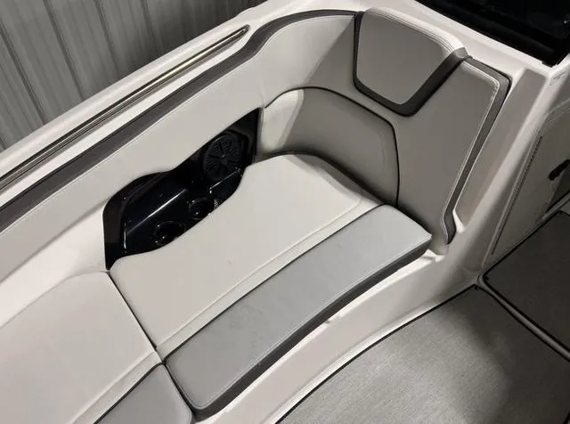 Slide: The Image of 2024 Yamaha Boats AR250 interior seating with cup holders and speaker. - 15
