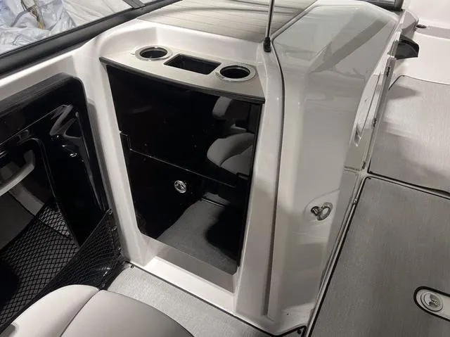 Slide: The Image of Interior of 2024 Yamaha Boats AR250, featuring storage compartments and cup holders. - 23