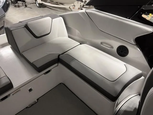 Slide: The Image of 2024 Yamaha Boats AR250 interior seating with modern design and comfortable cushions. - 24