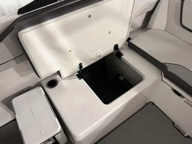 Slide: The Image of 2024 Yamaha Boats AR250 storage compartment and seating area. - 26