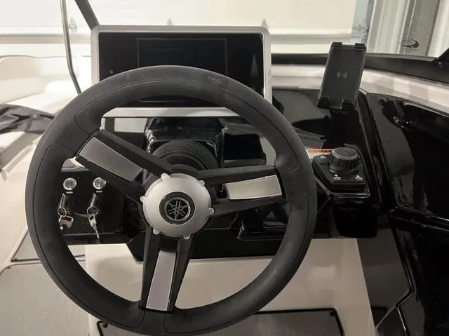 Slide: The Image of 2024 Yamaha Boats AR250 steering wheel and dashboard controls. - 30