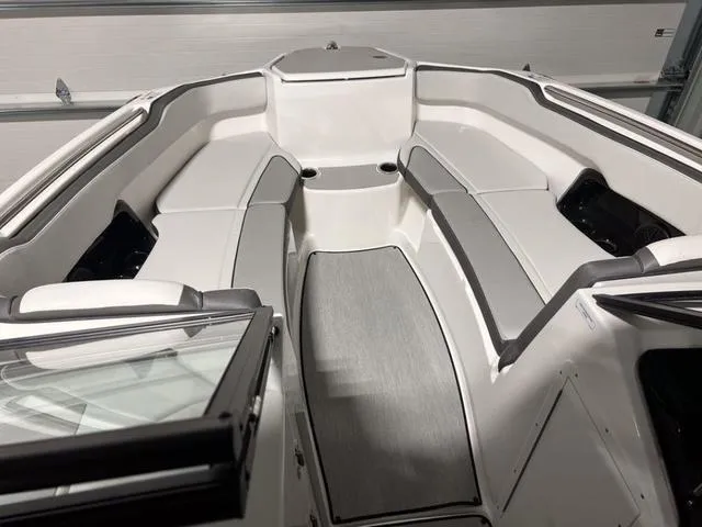 Slide: The Image of 2024 Yamaha Boats AR250 interior bow seating area with gray and white upholstery. - 7