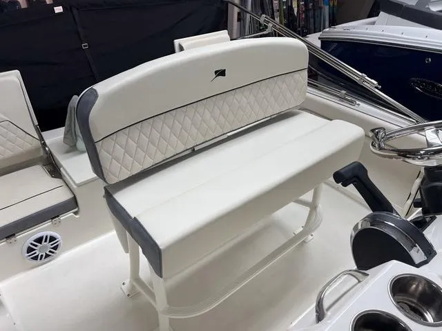 Slide: The Image of 2023 Stingray 173CC boat interior with white cushioned seating and steering console. - 10