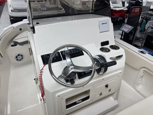 Slide: The Image of 2023 Stingray 173CC boat console with steering wheel and controls. - 11