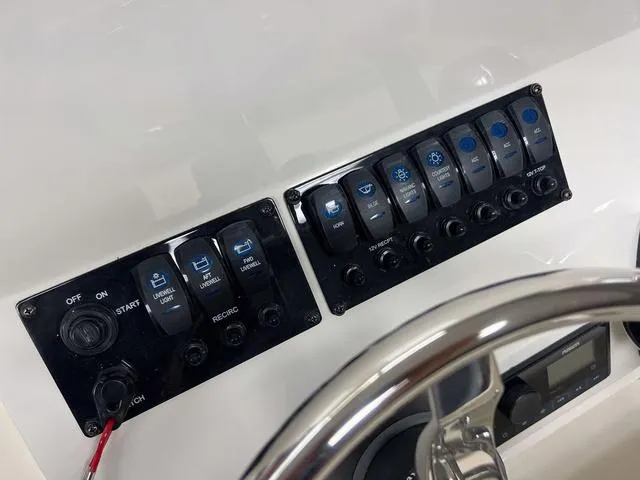 Slide: The Image of Control panel of 2023 Stingray 173CC boat with labeled switches and steering wheel. - 12