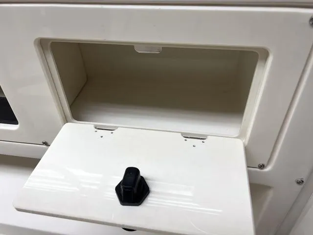 Slide: The Image of Open storage compartment on a 2023 Stingray 173CC boat. - 13