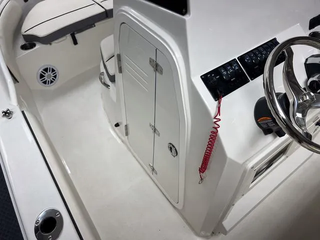 Slide: The Image of 2023 Stingray 173CC boat interior with steering wheel, control panel, and seating area. - 14