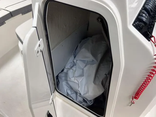 Slide: The Image of 2023 Stingray 173CC storage compartment with open door and interior view. - 15