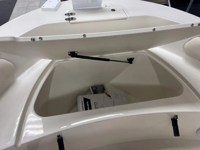 Slide: The Image of 2023 Stingray 173CC boat storage compartment with open lid. - 20