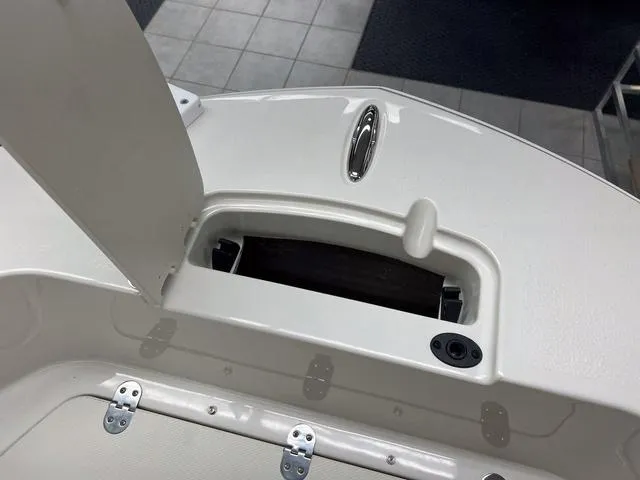 Slide: The Image of 2023 Stingray 173CC boat storage compartment with open hatch. - 22