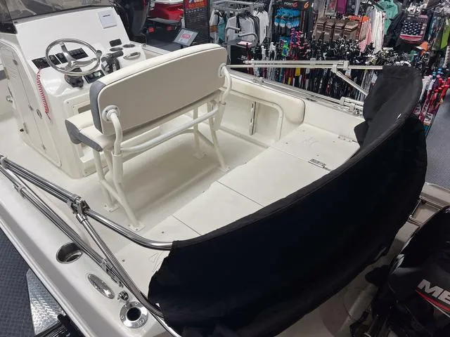 Slide: The Image of 2023 Stingray 173CC boat interior with seating and control console in showroom. - 4
