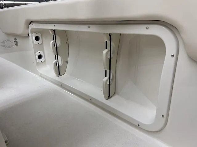 Slide: The Image of 2023 Stingray 173CC boat storage compartment with rod holders. - 9