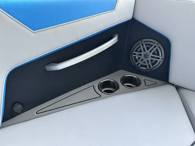 Slide: The Image of 2024 Nautique Super Air Nautique GS22 interior detail with speaker, cup holders, and handle. - 10