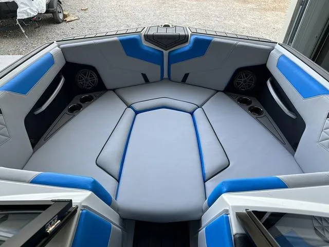 Slide: The Image of 2024 Nautique Super Air Nautique GS22 boat interior with blue and gray seating. - 11