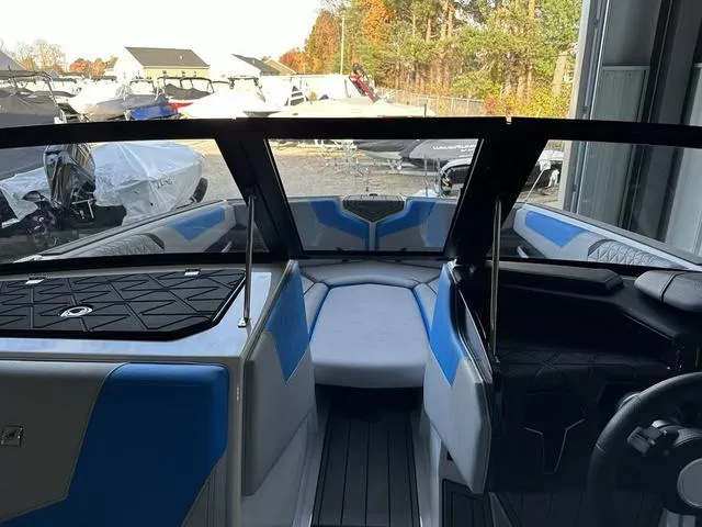 Slide: The Image of 2024 Nautique Super Air Nautique GS22 interior with blue and white seating. - 12