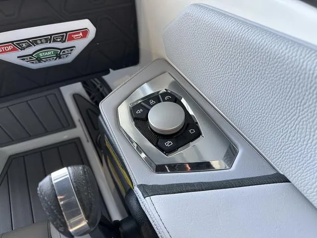 Slide: The Image of Control panel of 2024 Nautique Super Air Nautique GS22 boat with start/stop buttons. - 14