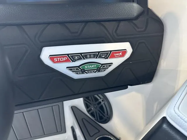 Slide: The Image of Control panel of 2024 Nautique Super Air Nautique GS22 boat with start and stop buttons. - 16