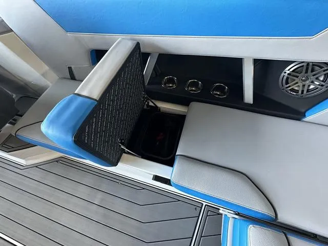 Slide: The Image of 2024 Nautique Super Air Nautique GS22 interior seating with storage compartment open. - 19