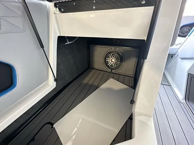 Slide: The Image of 2024 Nautique Super Air Nautique GS22 interior storage compartment with speaker. - 21