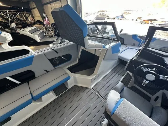 Slide: The Image of 2024 Nautique Super Air Nautique GS22 interior with blue and gray seating, modern dashboard. - 22