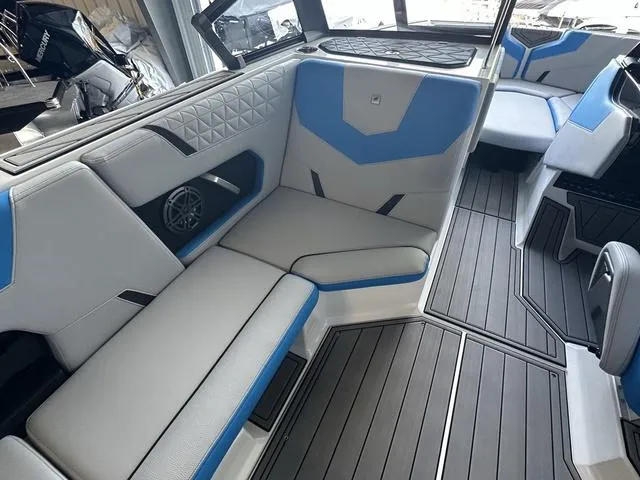 Slide: The Image of 2024 Nautique Super Air Nautique GS22 interior with blue and gray seating. - 28