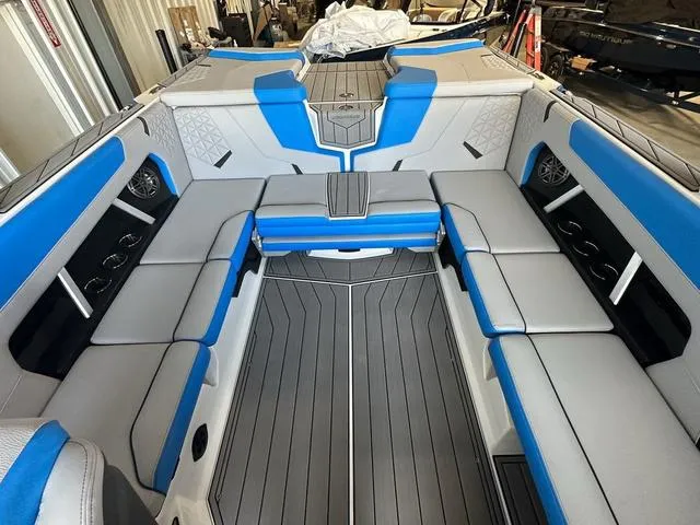 Slide: The Image of 2024 Nautique Super Air Nautique GS22 interior with blue and gray seating. - 30