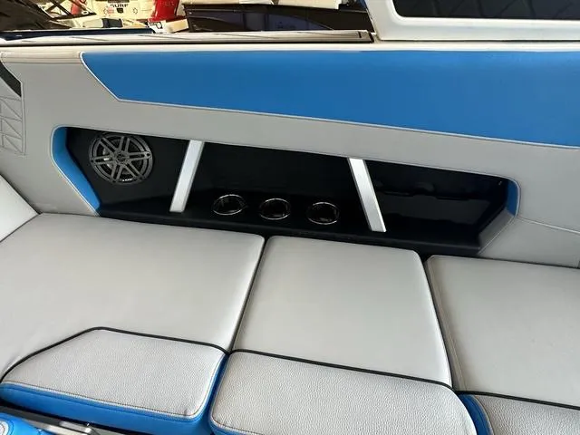 Slide: The Image of 2024 Nautique Super Air Nautique GS22 interior seating with blue and gray upholstery. - 31