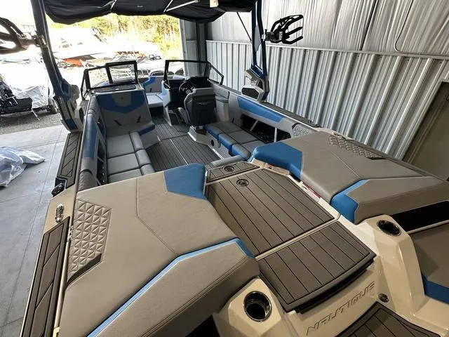 Slide: The Image of 2024 Nautique Super Air Nautique GS22 interior, spacious seating, modern design, luxury boat. - 35