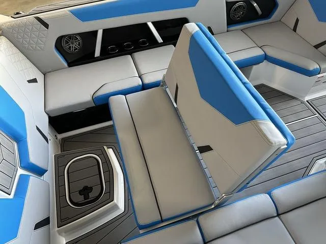 Slide: The Image of 2024 Nautique Super Air Nautique GS22 interior with blue and gray seating. - 4