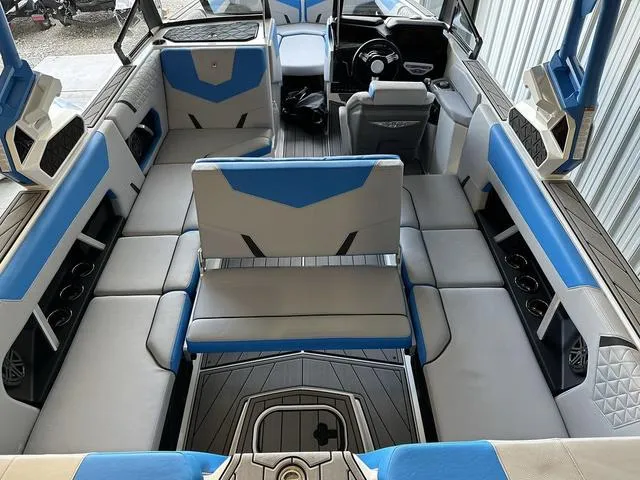 Slide: The Image of 2024 Nautique Super Air Nautique GS22 interior with blue and gray seating. - 5