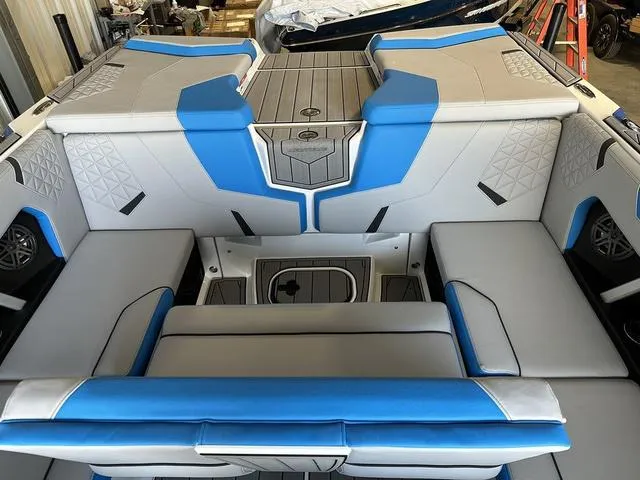 Slide: The Image of 2024 Nautique Super Air Nautique GS22 interior with blue and gray upholstery. - 6