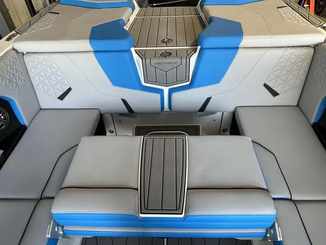 Slide: The Image of 2024 Nautique Super Air Nautique GS22 interior with blue and gray seating. - 7