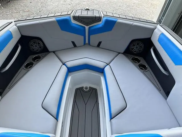 Slide: The Image of 2024 Nautique Super Air Nautique GS22 boat interior with blue and white seating. - 8
