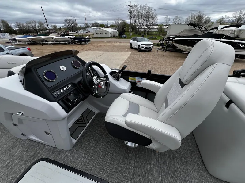 Slide: The Image of Interior of 2022 Viaggio 23U Diamante boat with captain's chair and control panel. - 12