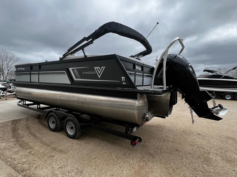 Slide: The Image of 2022 Viaggio 23U Diamante pontoon boat with Mercury outboard motor on trailer. - 2
