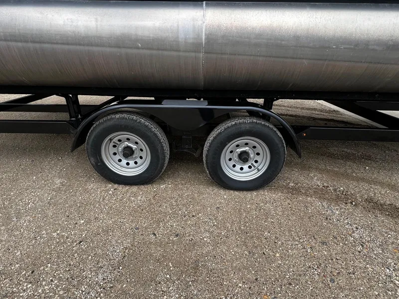 Slide: The Image of Dual axle wheels of a 2022 Viaggio 23U Diamante trailer on gravel. - 24