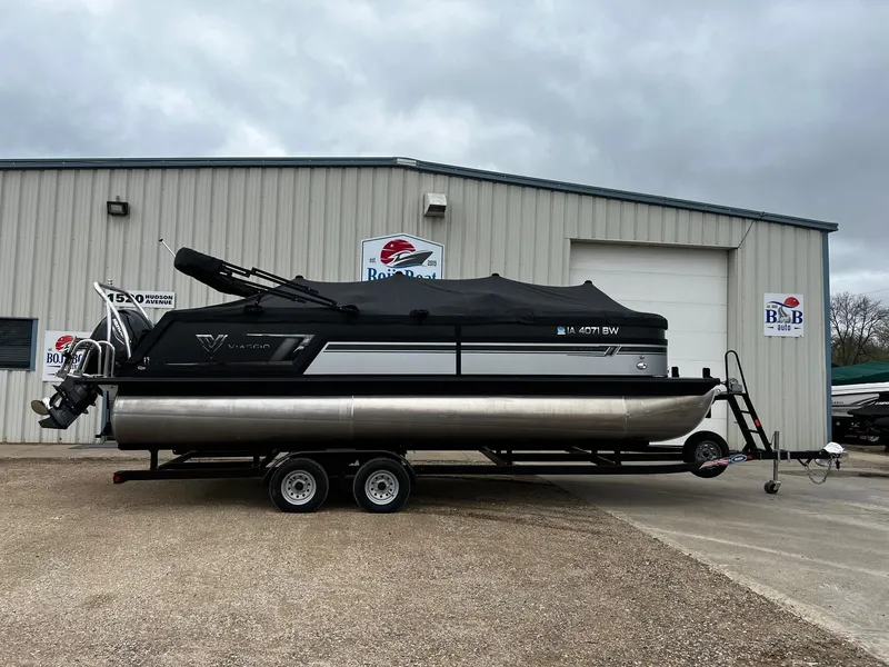 Slide: The Image of 2022 Viaggio 23U Diamante pontoon boat on trailer outside a boat dealership. - 26