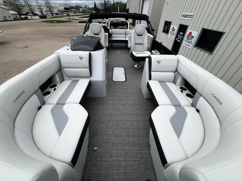 Slide: The Image of 2022 Viaggio 23U Diamante pontoon boat with luxurious white and gray seating. - 6
