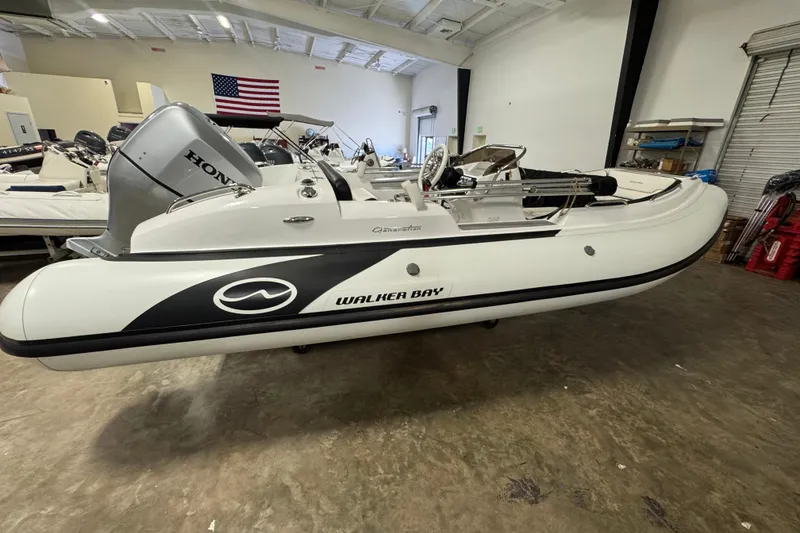 The Image of 2021 Walker Bay Generation 525 DLX boat with Honda engine in showroom. - 0