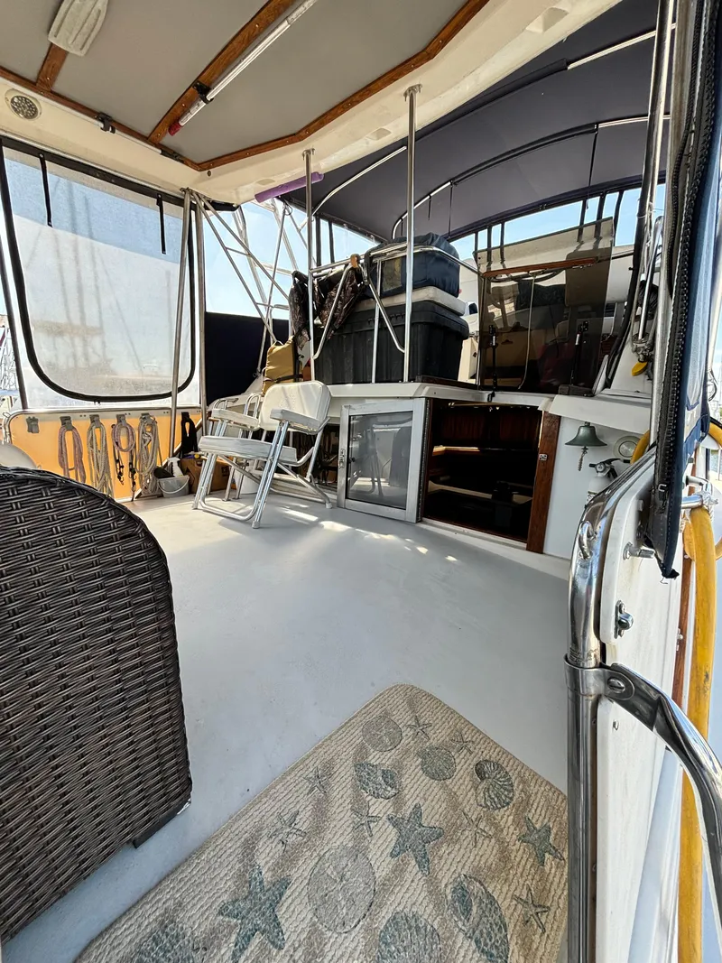 Slide: The Image of 1987 Silverton AFT CABIN boat interior with seating and storage. - 12