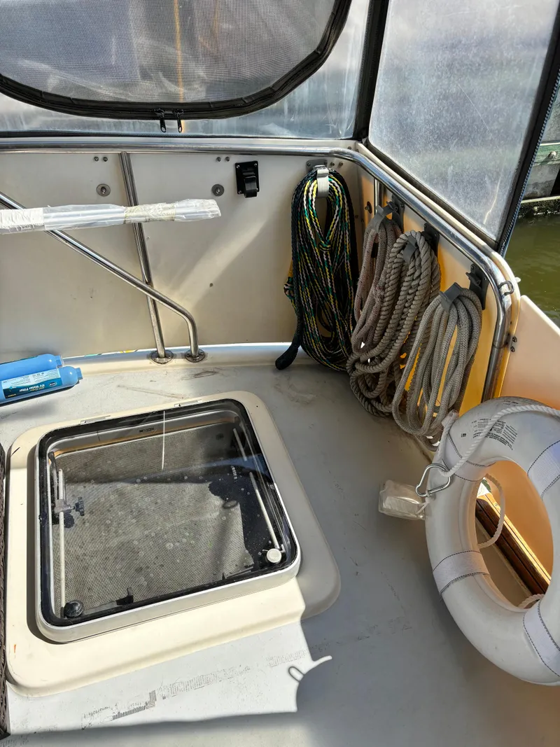 Slide: The Image of 1987 Silverton AFT CABIN boat interior with ropes and life preserver. - 15