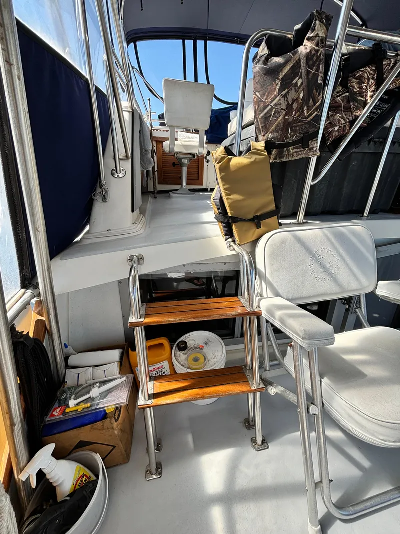 Slide: The Image of 1987 Silverton AFT CABIN interior with seating, steps, and storage. - 16