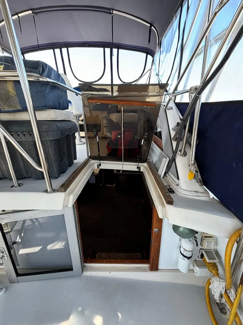 Slide: The Image of 1987 Silverton AFT CABIN yacht interior entrance with canopy and railing. - 17