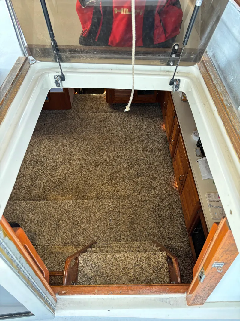 Slide: The Image of Interior view of 1987 Silverton AFT CABIN with carpeted stairs and wooden cabinets. - 18