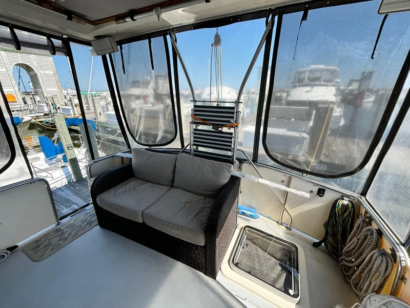 Slide: The Image of 1987 Silverton AFT CABIN interior with sofa, marina view, and nautical equipment. - 19